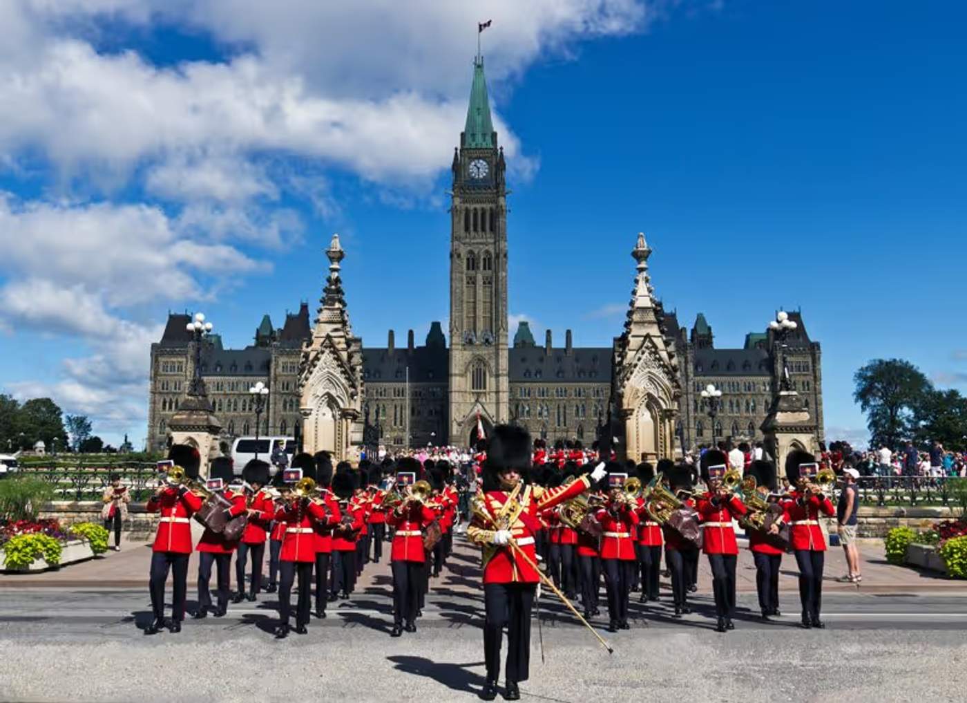 Parliament Hill à Ottawa avec des soldats en uniforme rouge lors d’une cérémonie officielle.