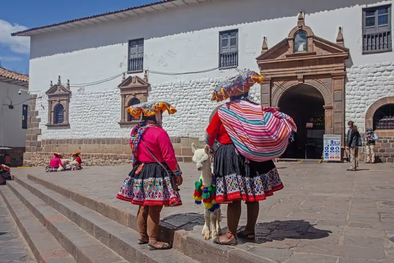 Scène de rue à Cusco avec des habitants en habits traditionnels péruviens.