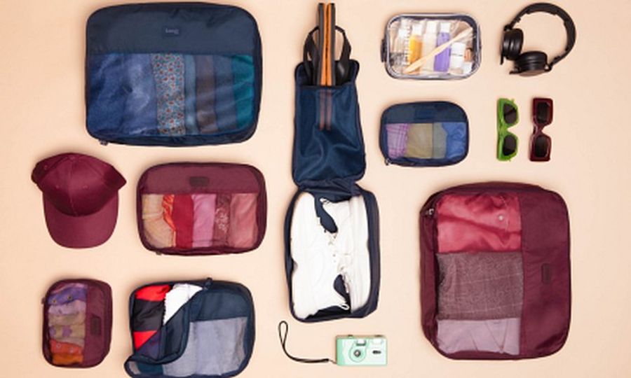 Organisateurs de bagages et accessoires de voyage disposés à plat pour préparer un road trip