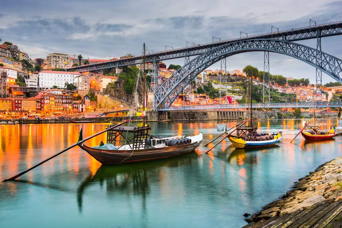 Vue pittoresque du pont Dom Luís I et des bateaux traditionnels sur le fleuve Douro à Porto.