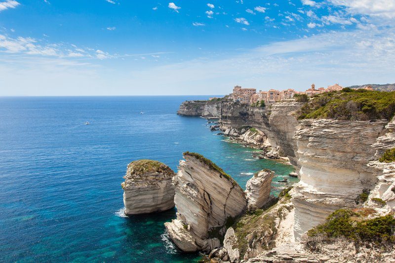 Les falaises de Bonifacio en Corse, avec ses maisons perchées sur des rochers surplombant la mer.