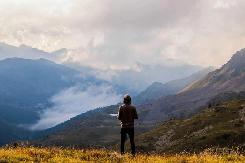 Une personne debout face à des montagnes françaises