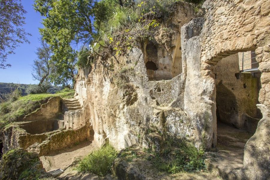 Grottes rupestres entourées de végétation à Zungri