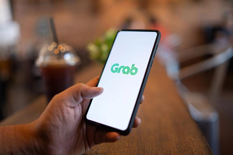 Écran de l’application Grab sur smartphone, service de transport et livraison très utilisé en Asie du Sud-Est.