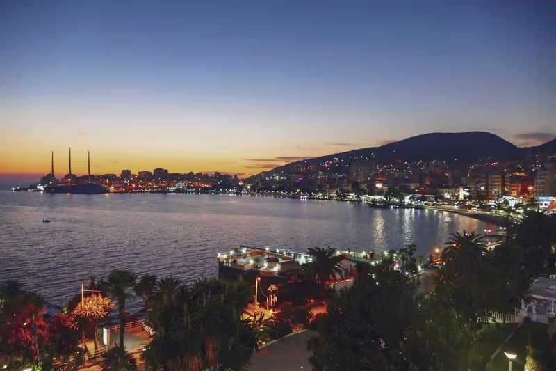 Vue nocturne sur Saranda, avec la ville illuminée le long de la côte albanaise.