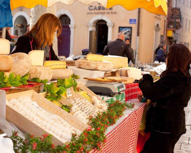 Stand de fromages et produits locaux au marché provençal de Cassis.