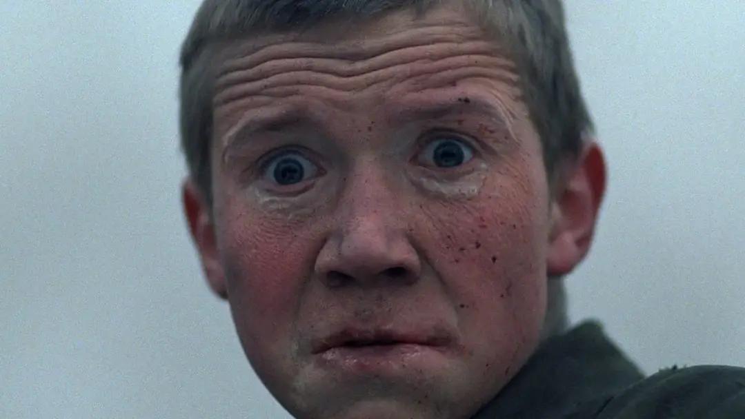 a terrified face of a young boy