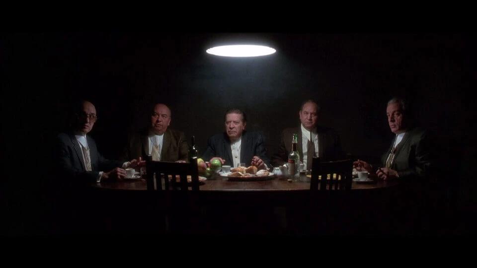 stylistic shot of men sitting at a table