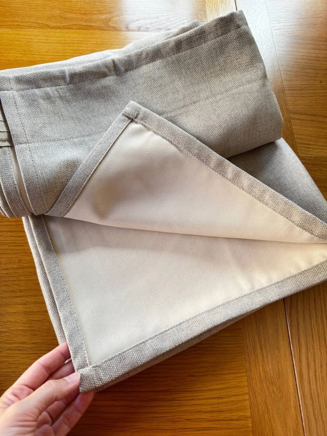 A finished corner: the grey face fabric turned neatly over the cream lining