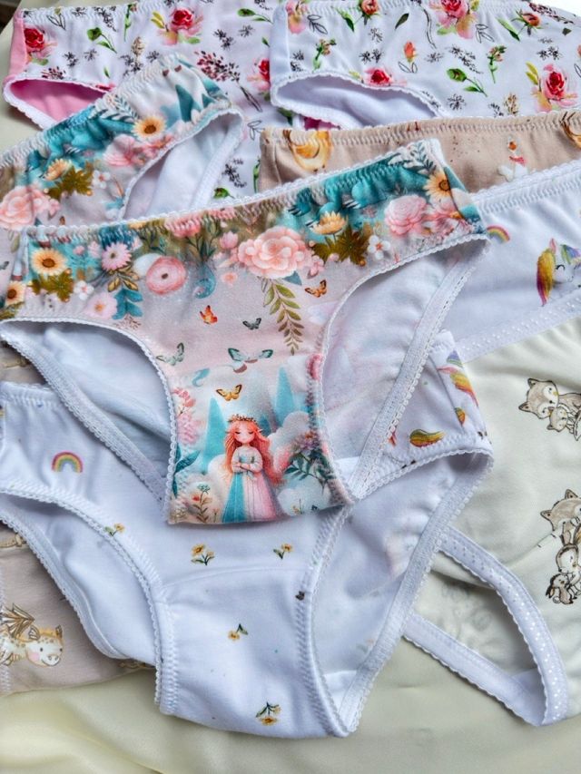 Children's knickers in fairy, flower and rainbow prints laid out together