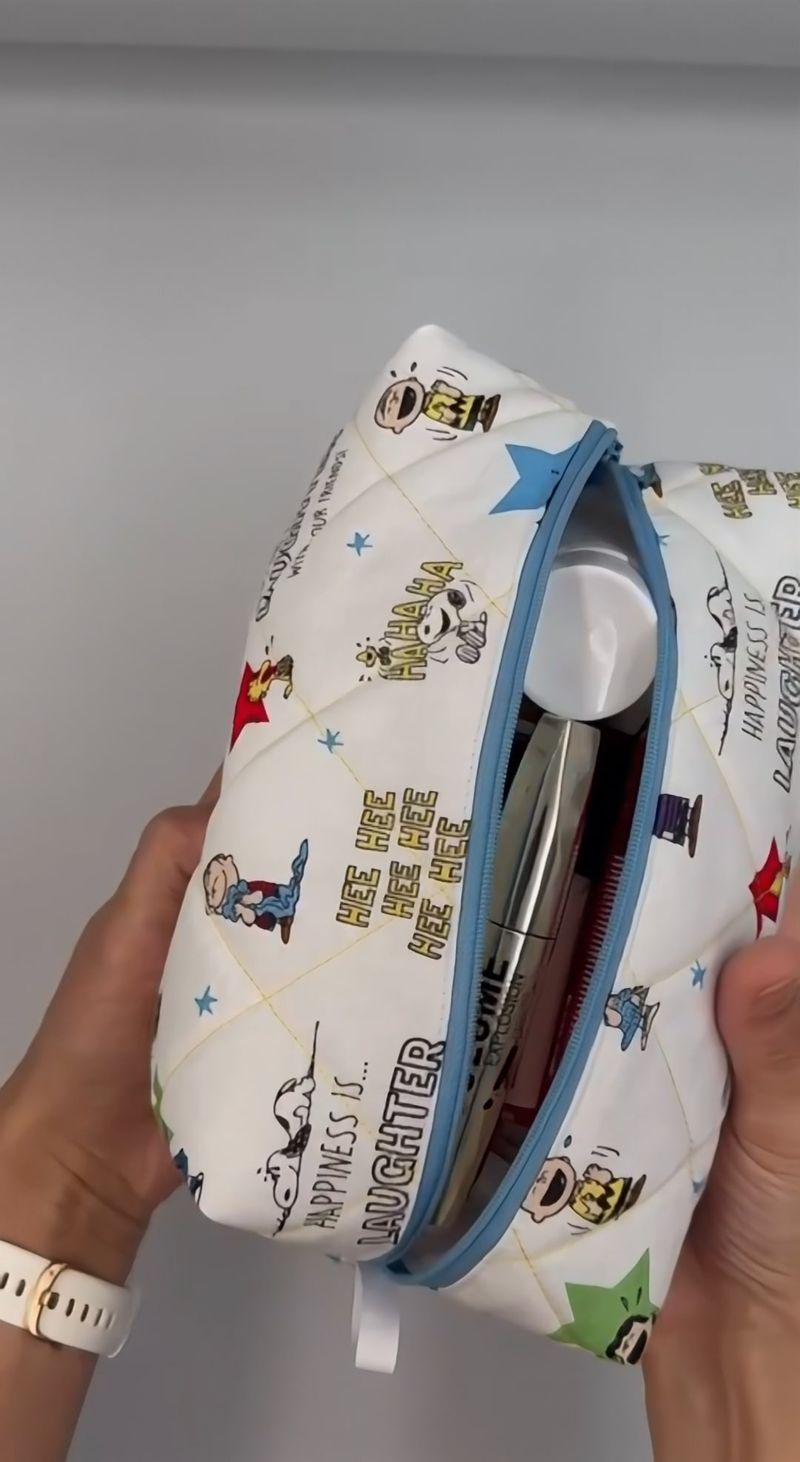 Unzipping a quilted cartoon-print wash bag to show the toiletries inside