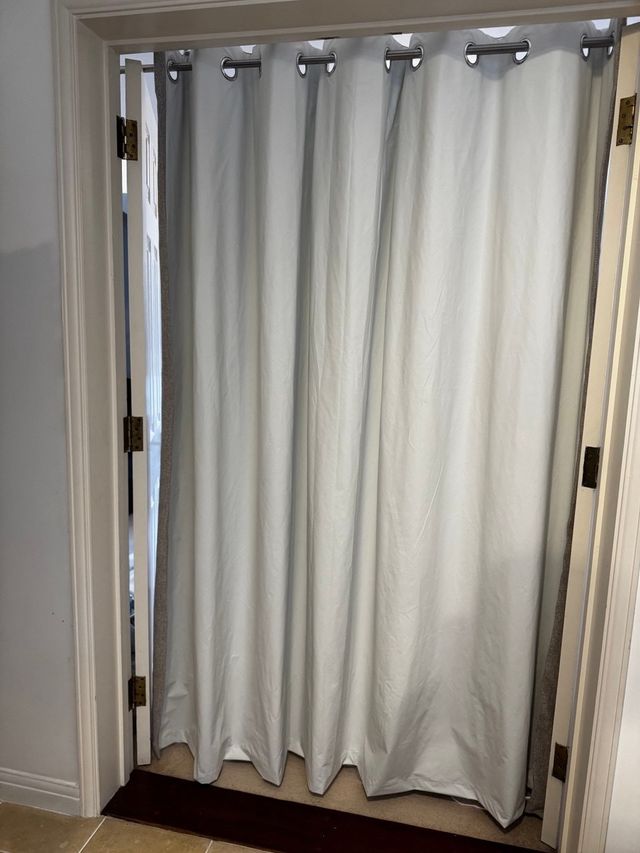 The same curtain after, hanging straight and just clearing the floor