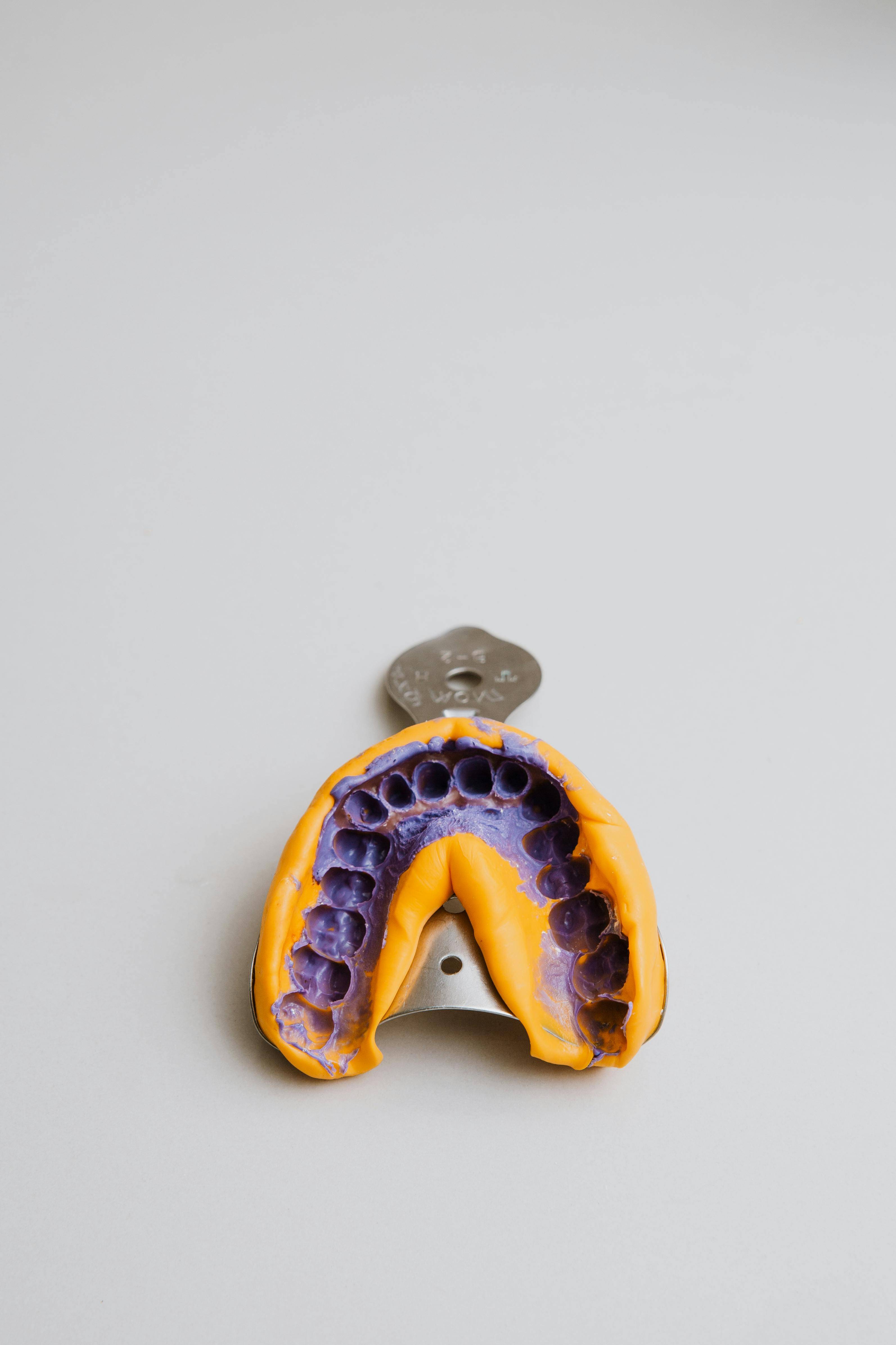 Impression model tray taken of a patients teeth showing the imprinted mould used to make the mouth guard