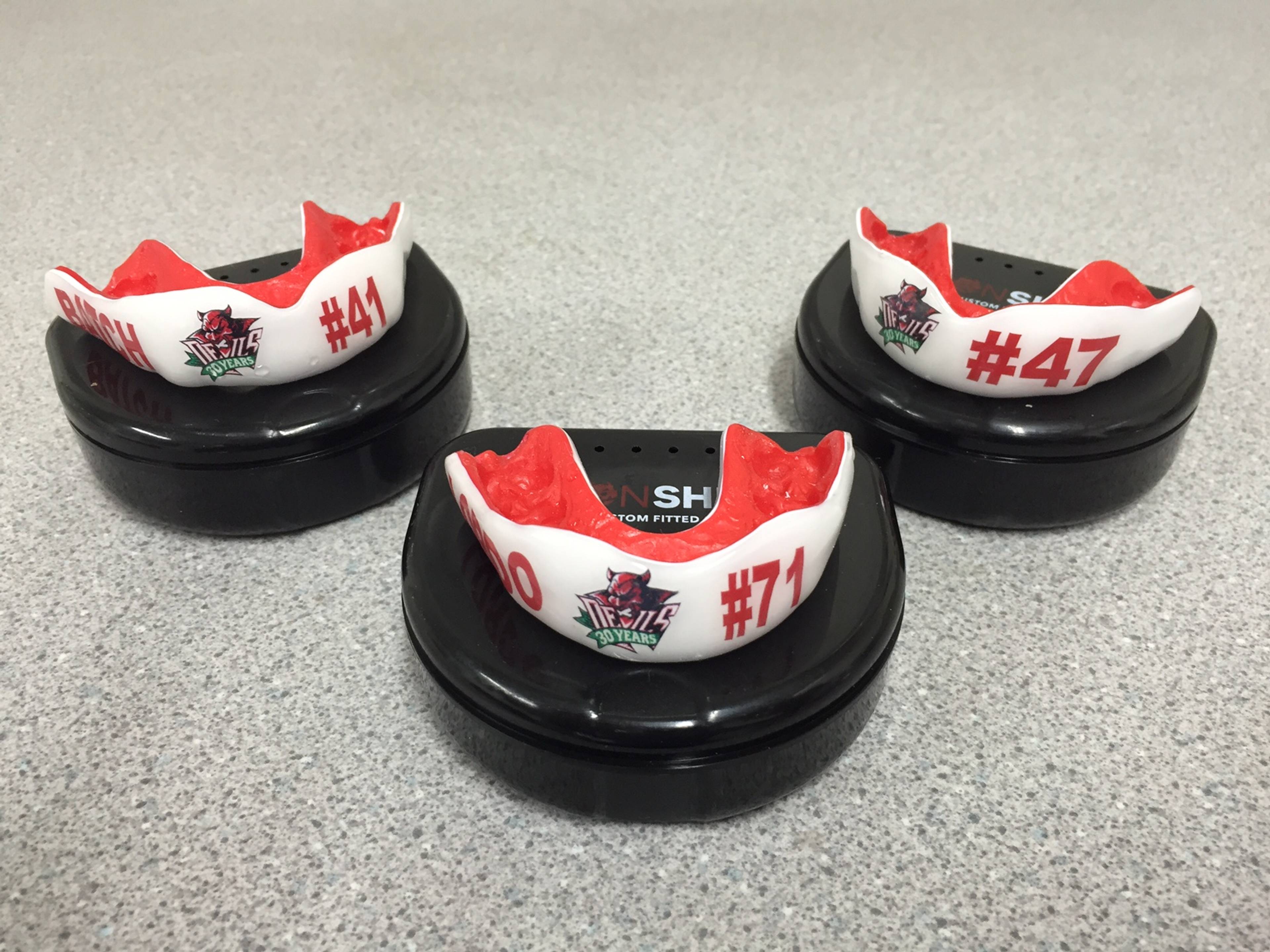 Three branded Cardiff Devils sport guards on black cases in a clean surgery at Pontcanna Dental Care
