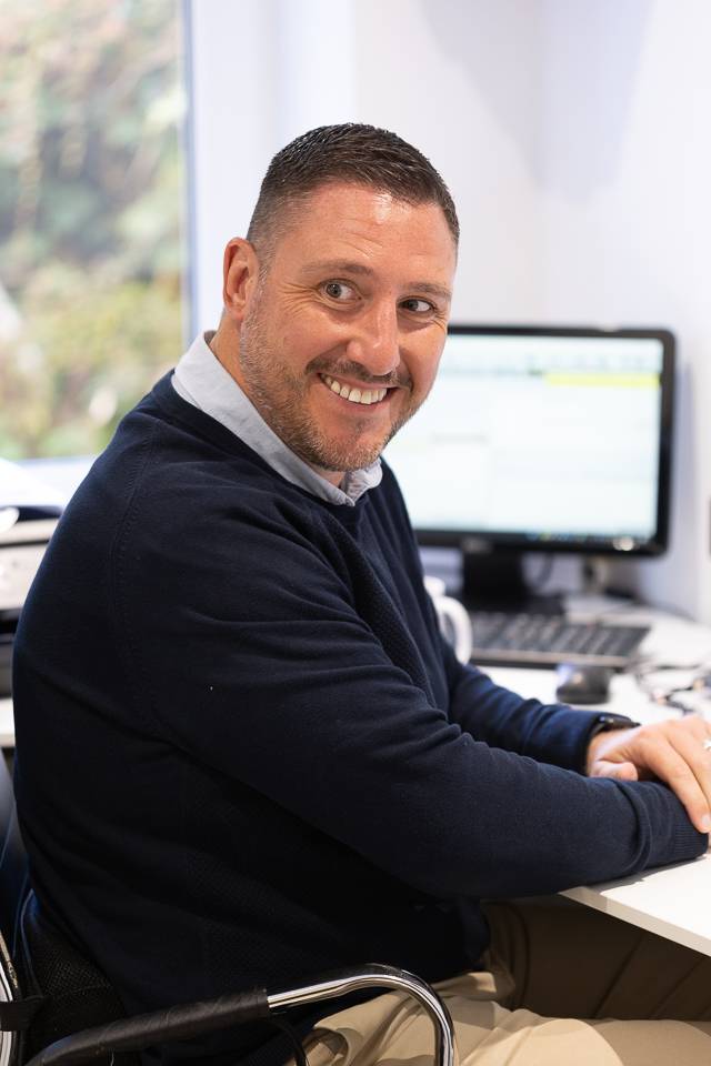 Pontcanna Dental Care manager at the desk and smiling at the camera