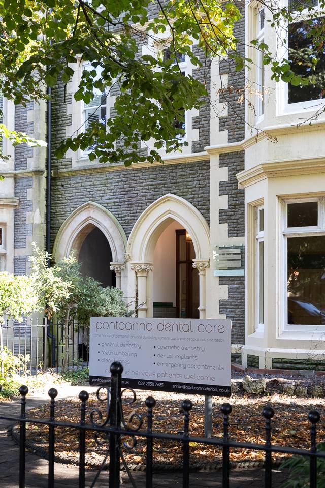 outside the front garden at pontcanna dental care featuring the arch doorway, bay window, and brand signage on a sunny day