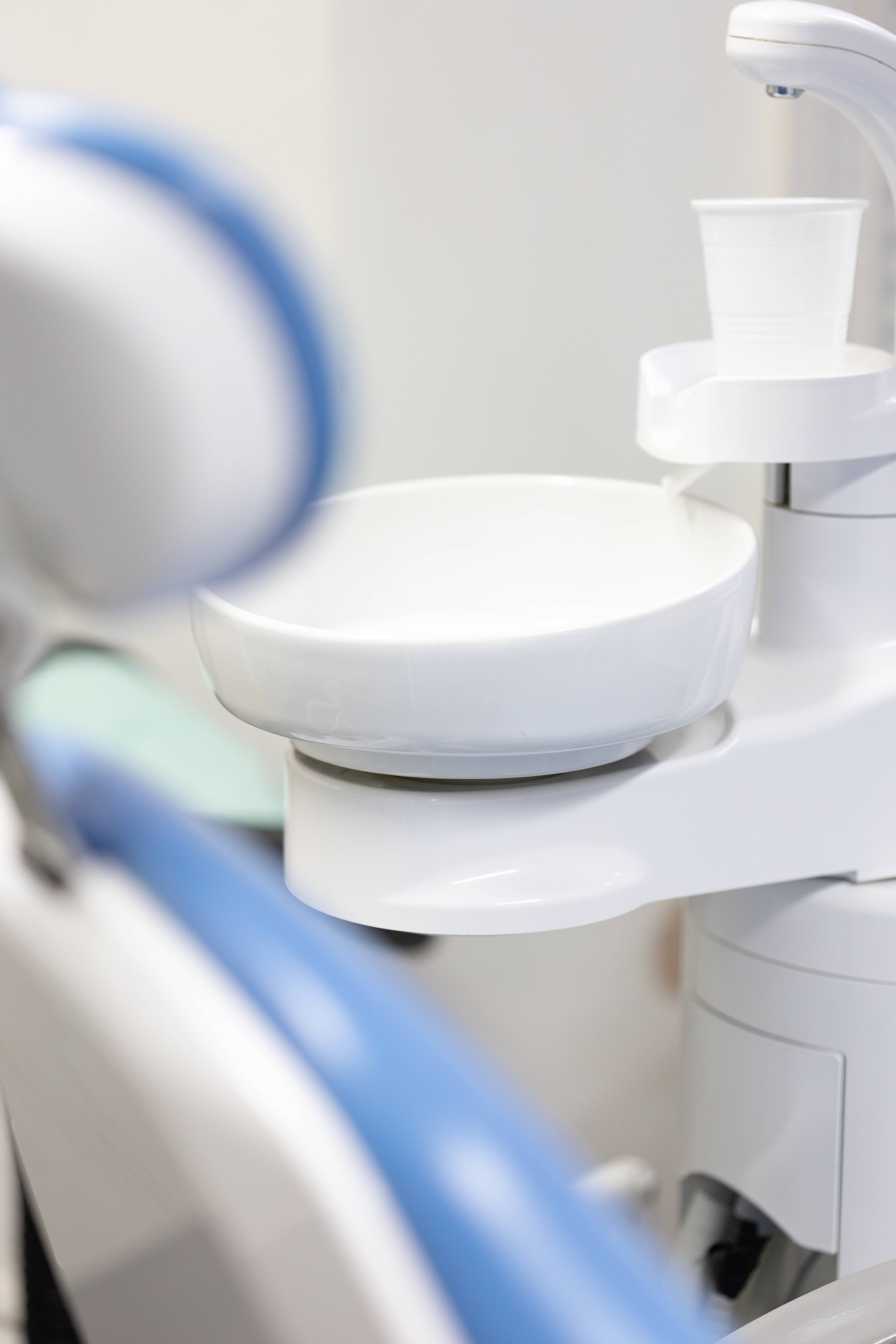 hygienic dental chair and mouth rinse station in dental surgery