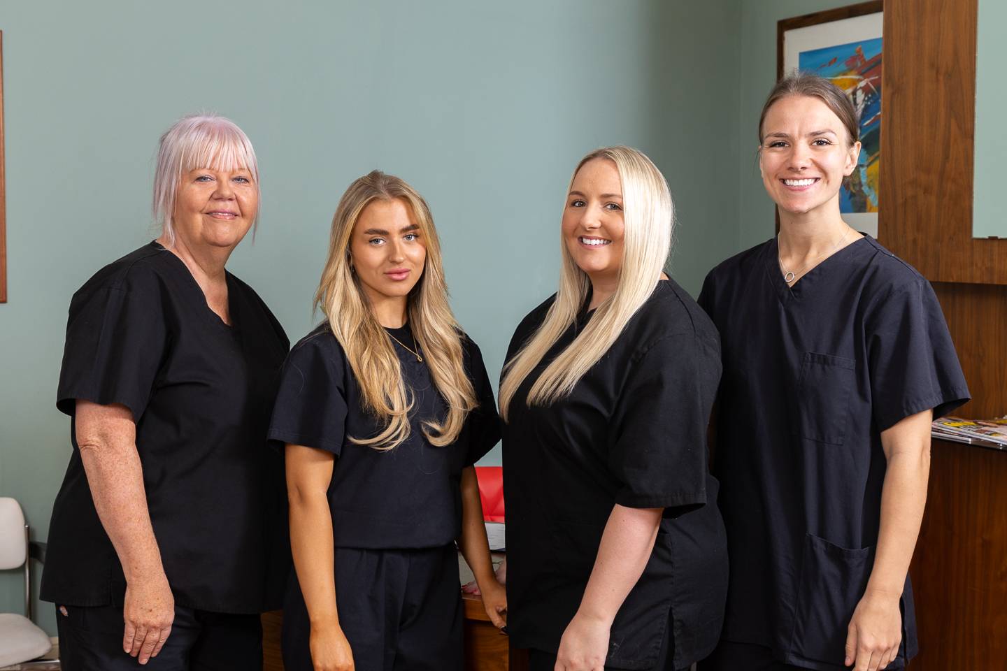Pontcanna Dental Care nurse team in black scrubs smiling at camera