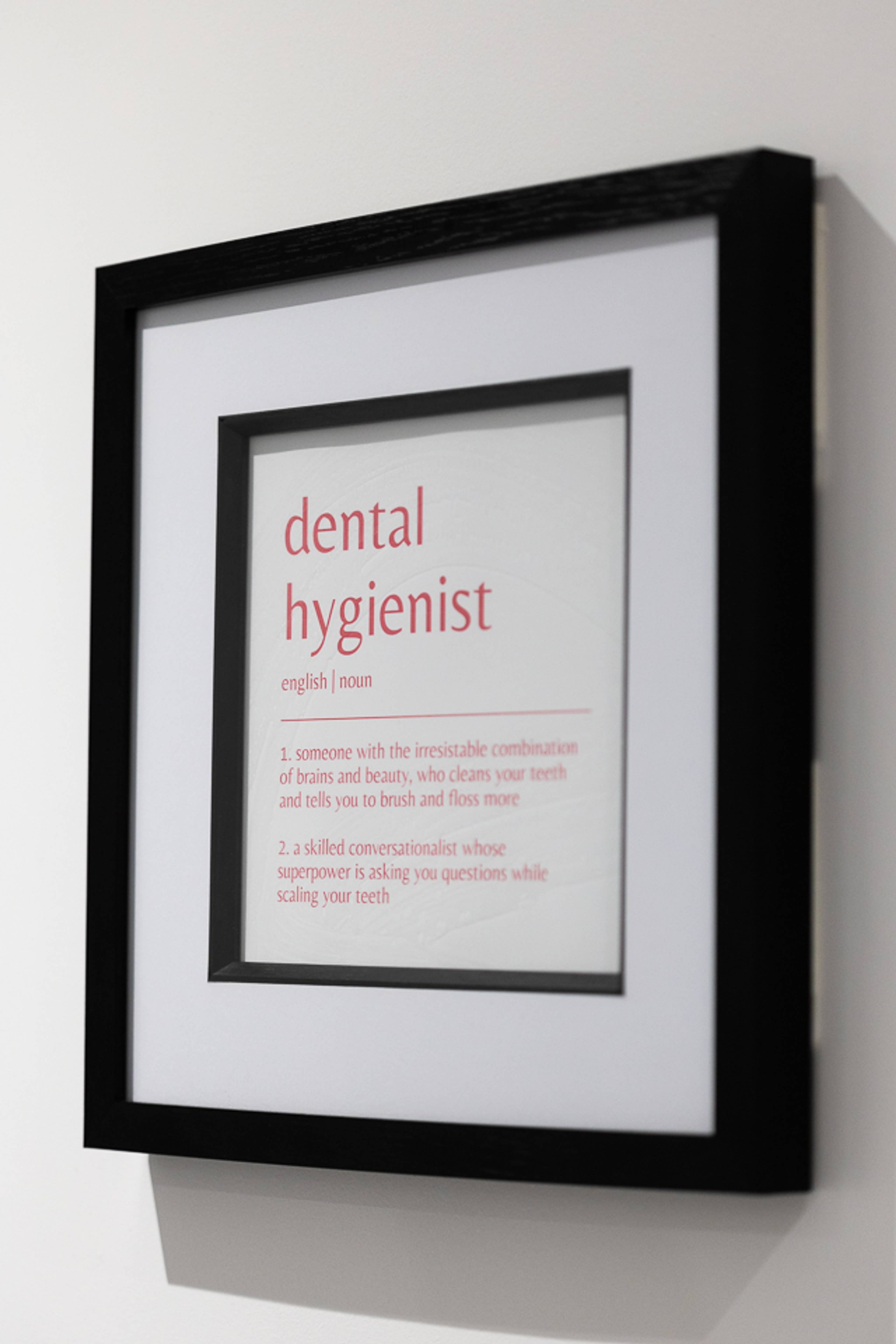 Black and white picture frame featuring the words "dental hygienist" hanging on the wall at Pontcanna Dental