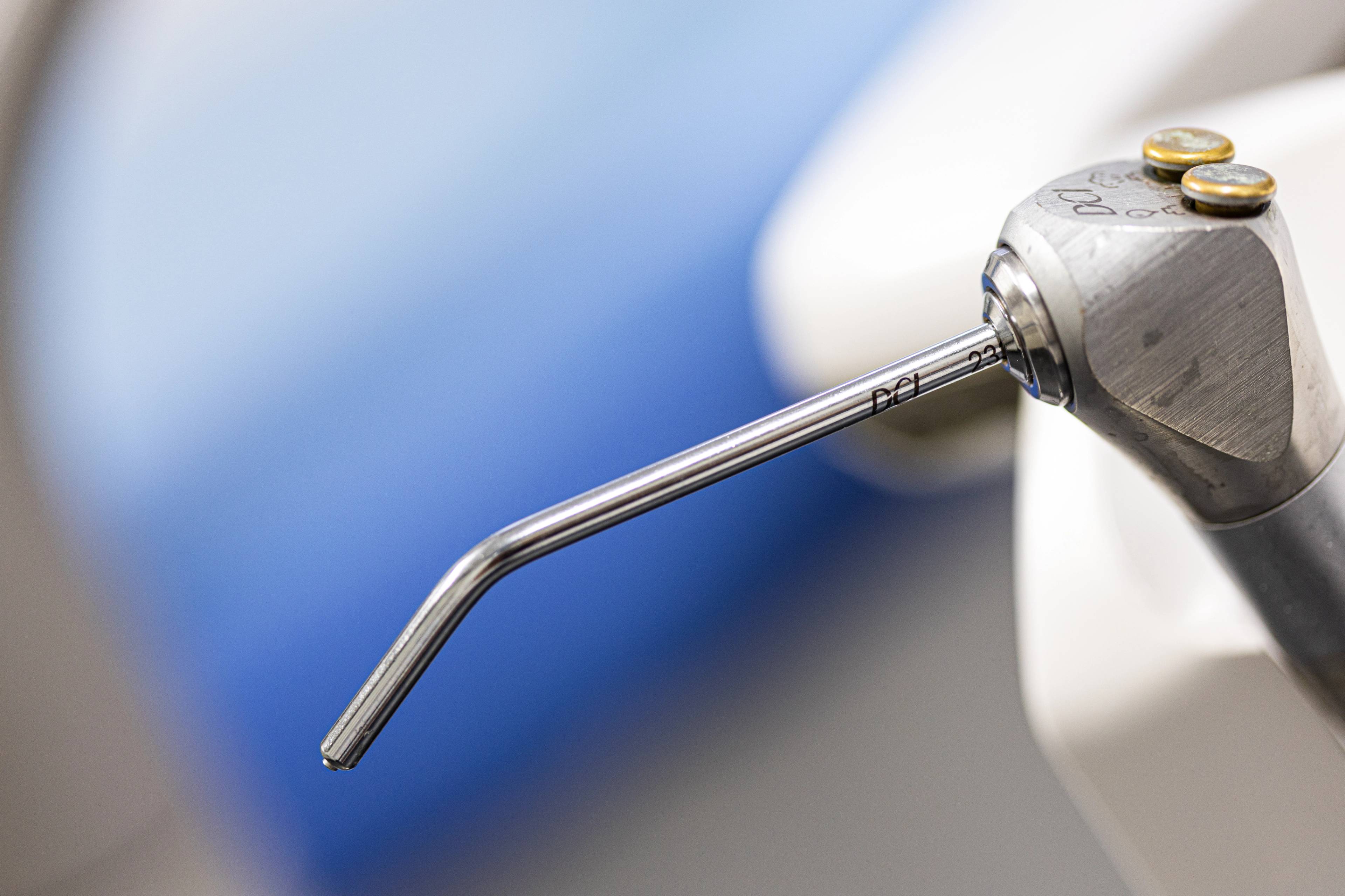 Dental hygienist tools up close on a blue background