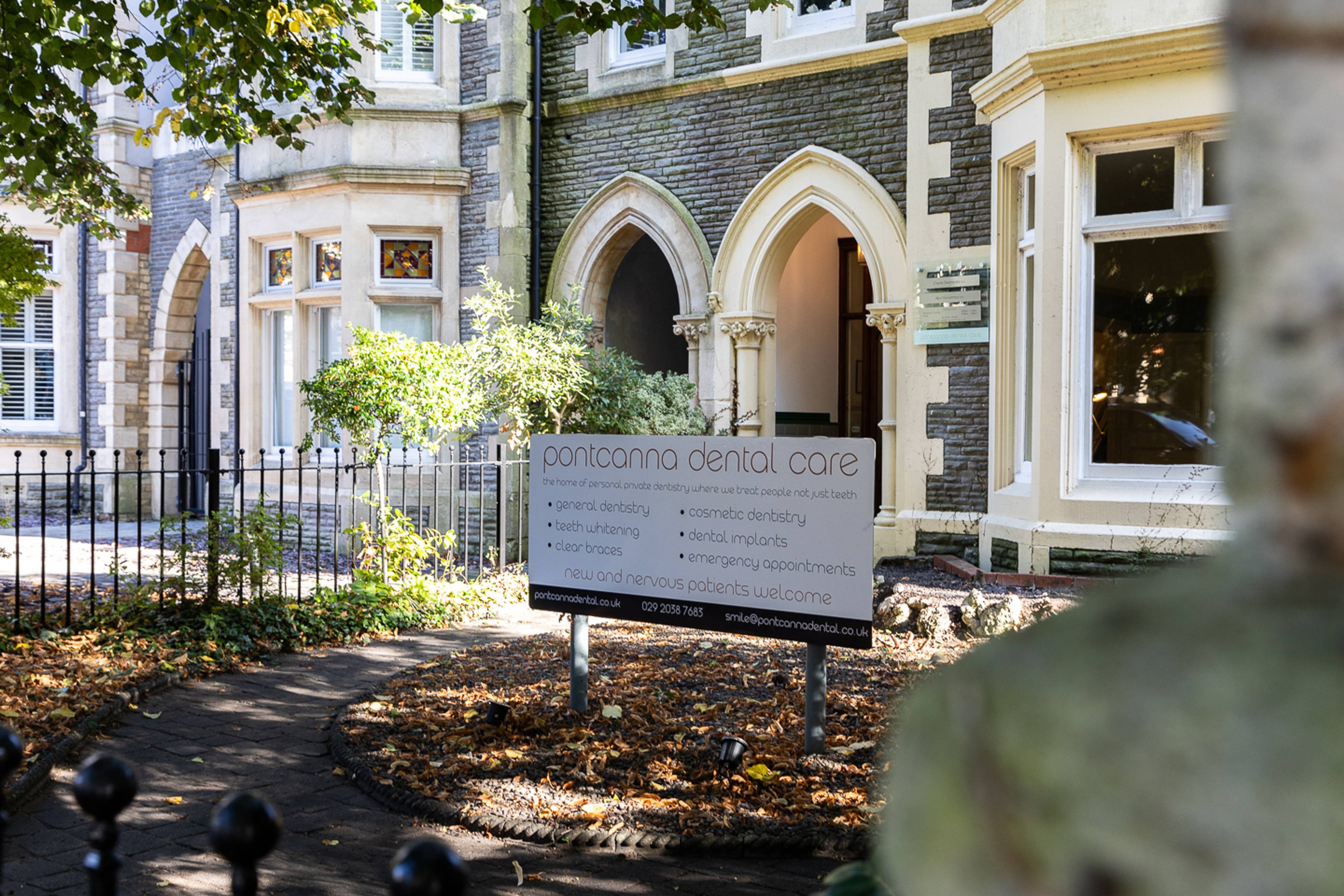 Outside Pontcanna Dental Care front garden with signage