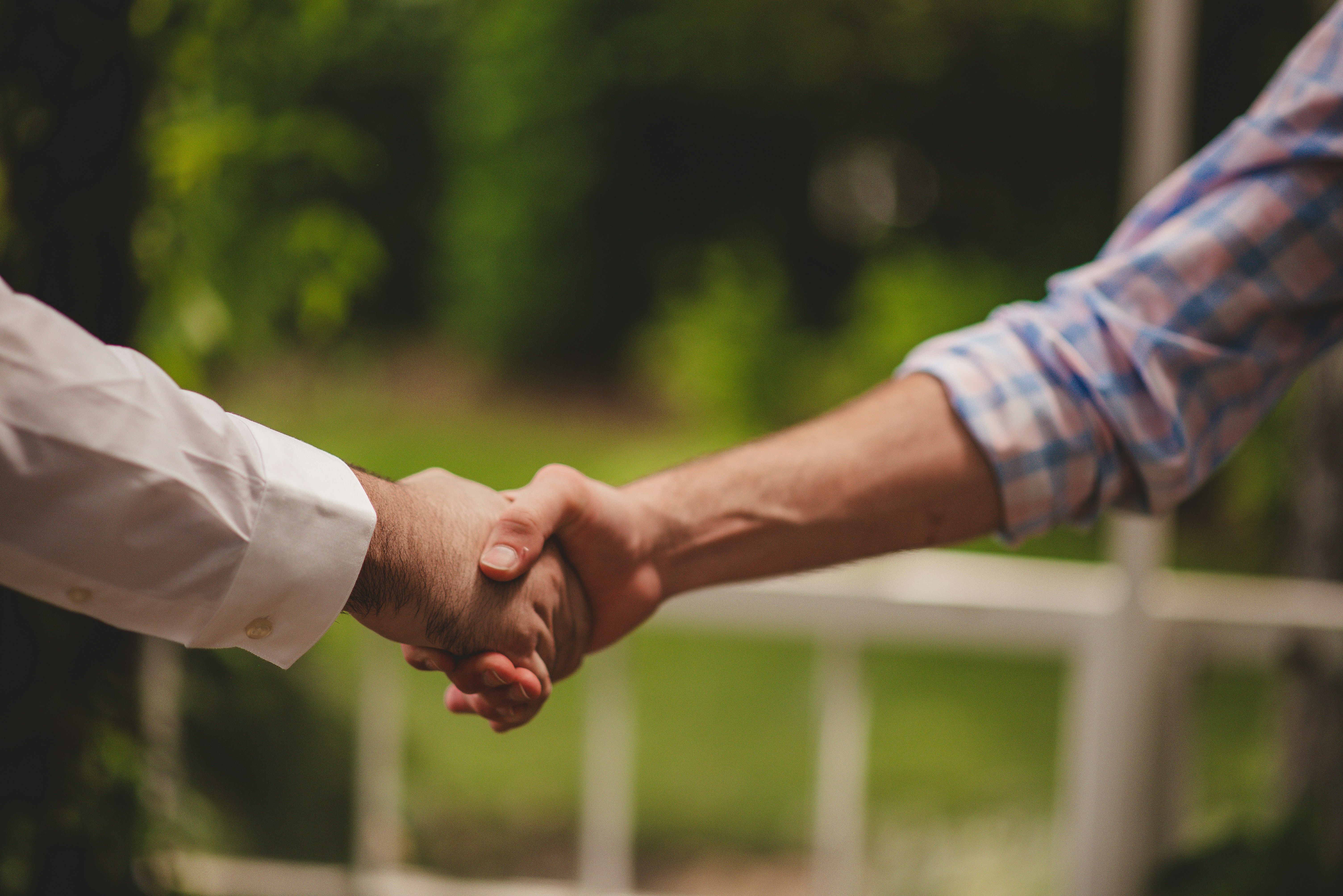 Close-up of shaking hands during business meeting