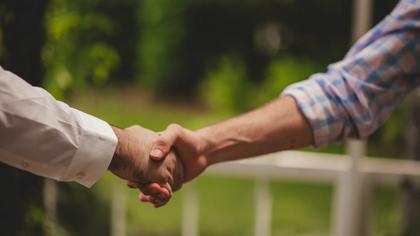 Close-up of shaking hands during business meeting