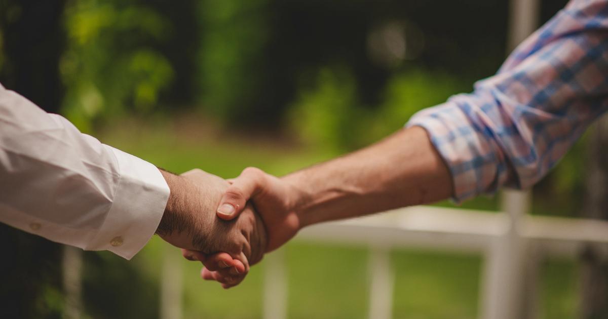 Close-up of shaking hands during business meeting