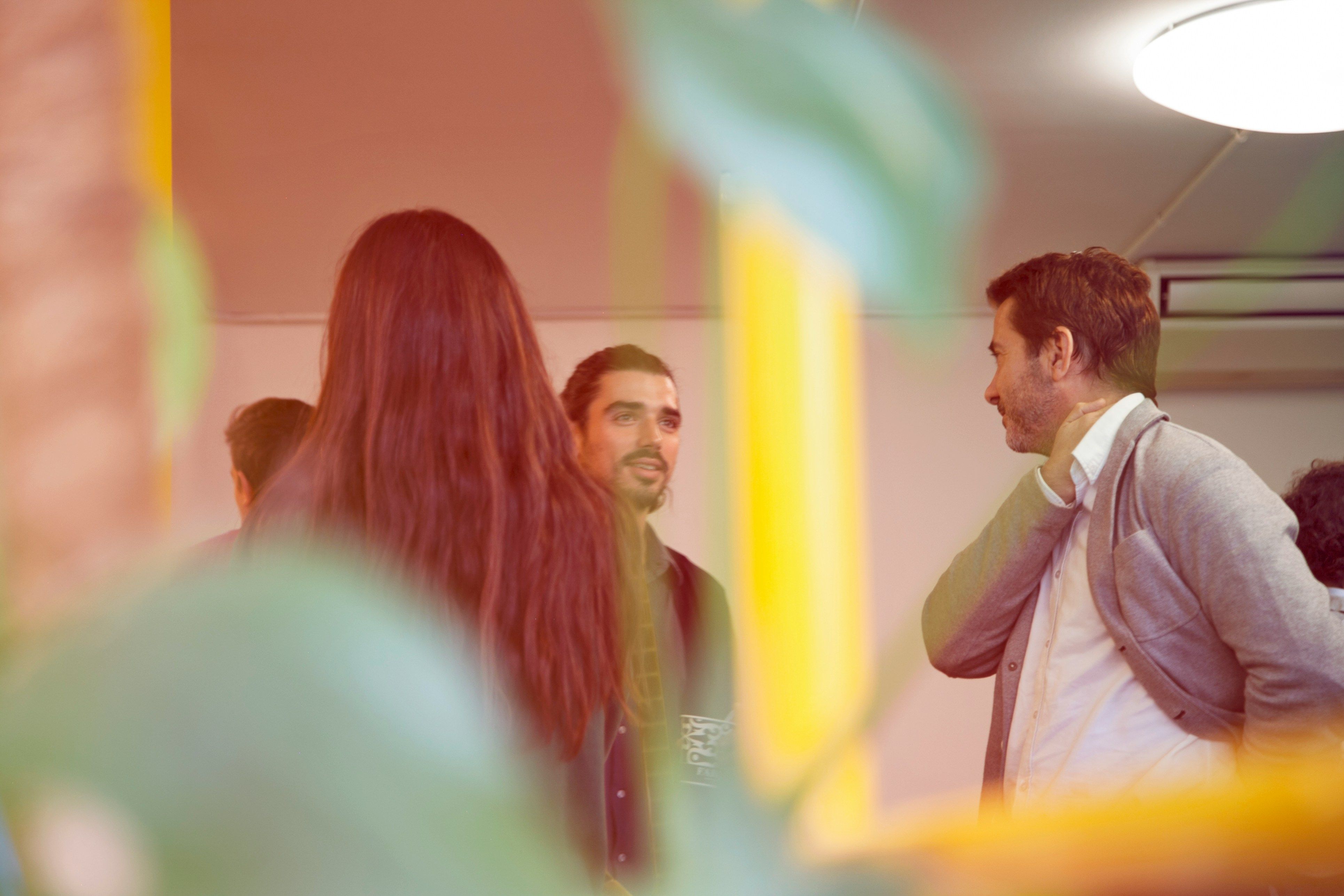 A group of people talking from a hidden perspective