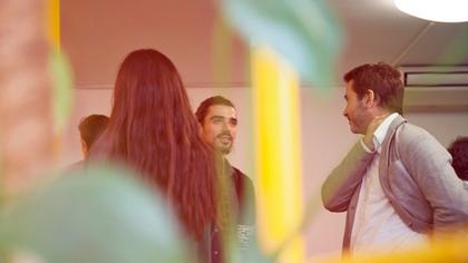 A group of people talking from a hidden perspective