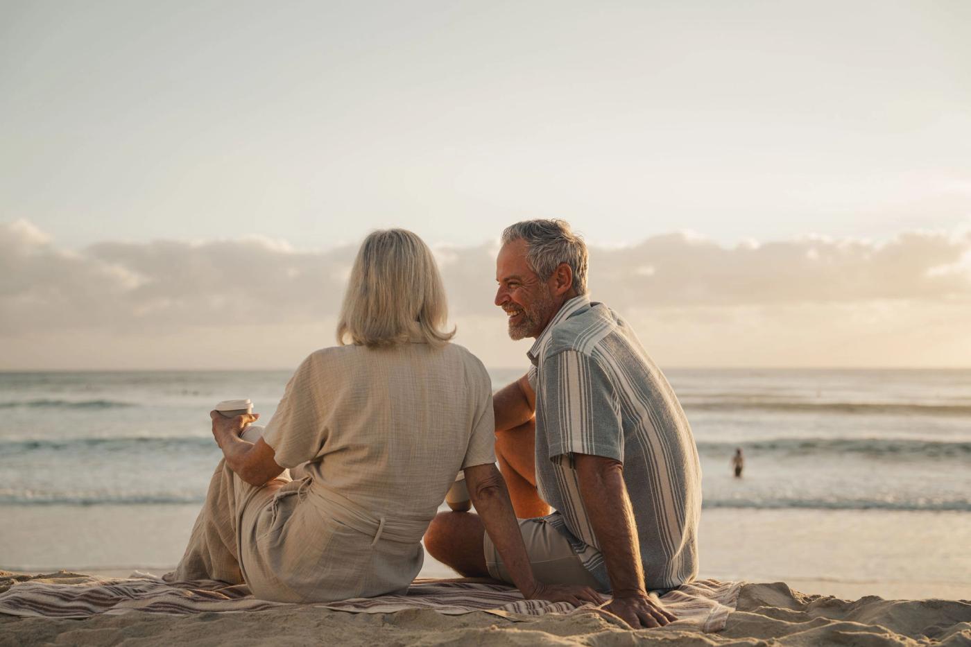 Couple enjoying coffee on the beach.