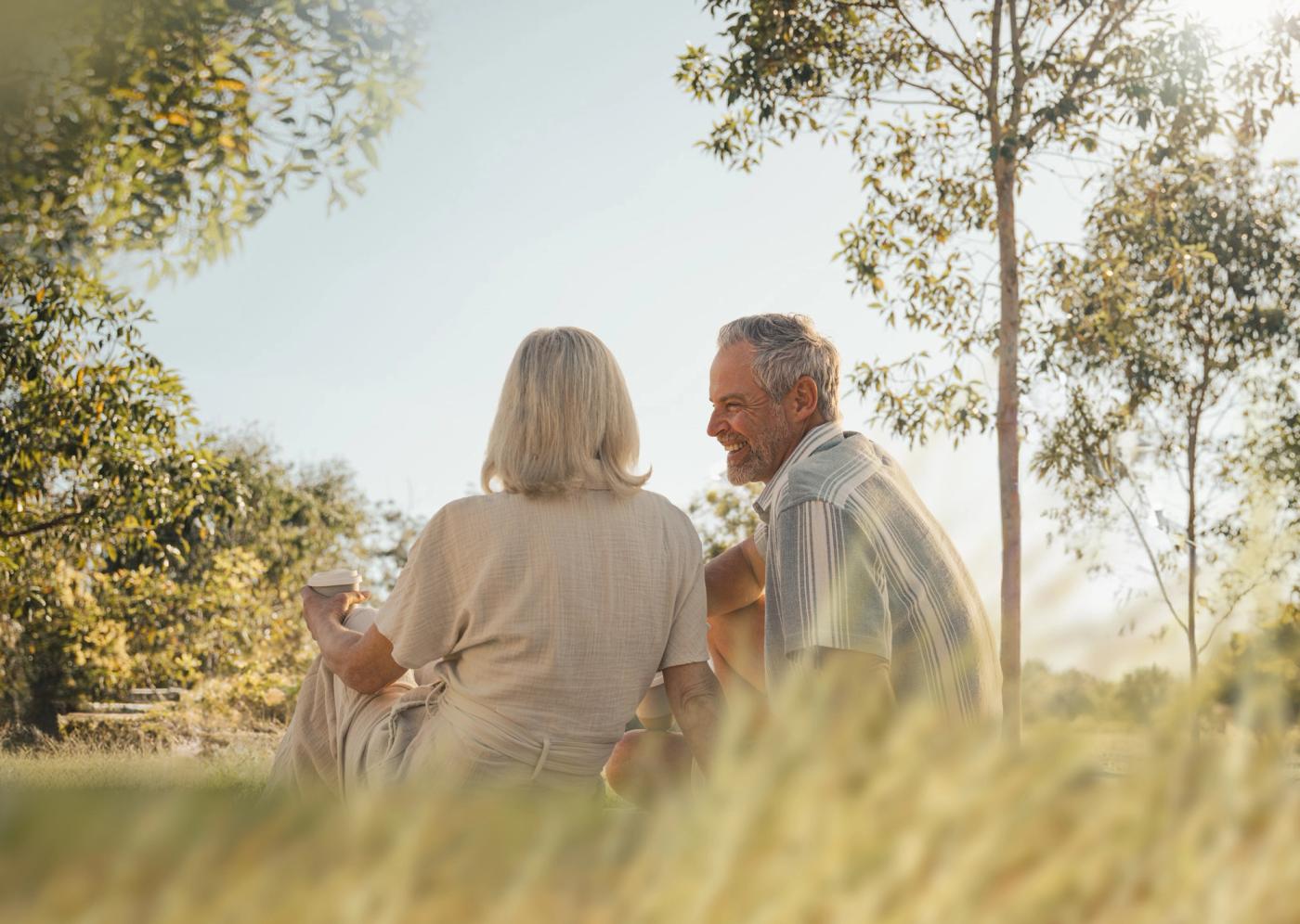 Couple drinking coffee in park