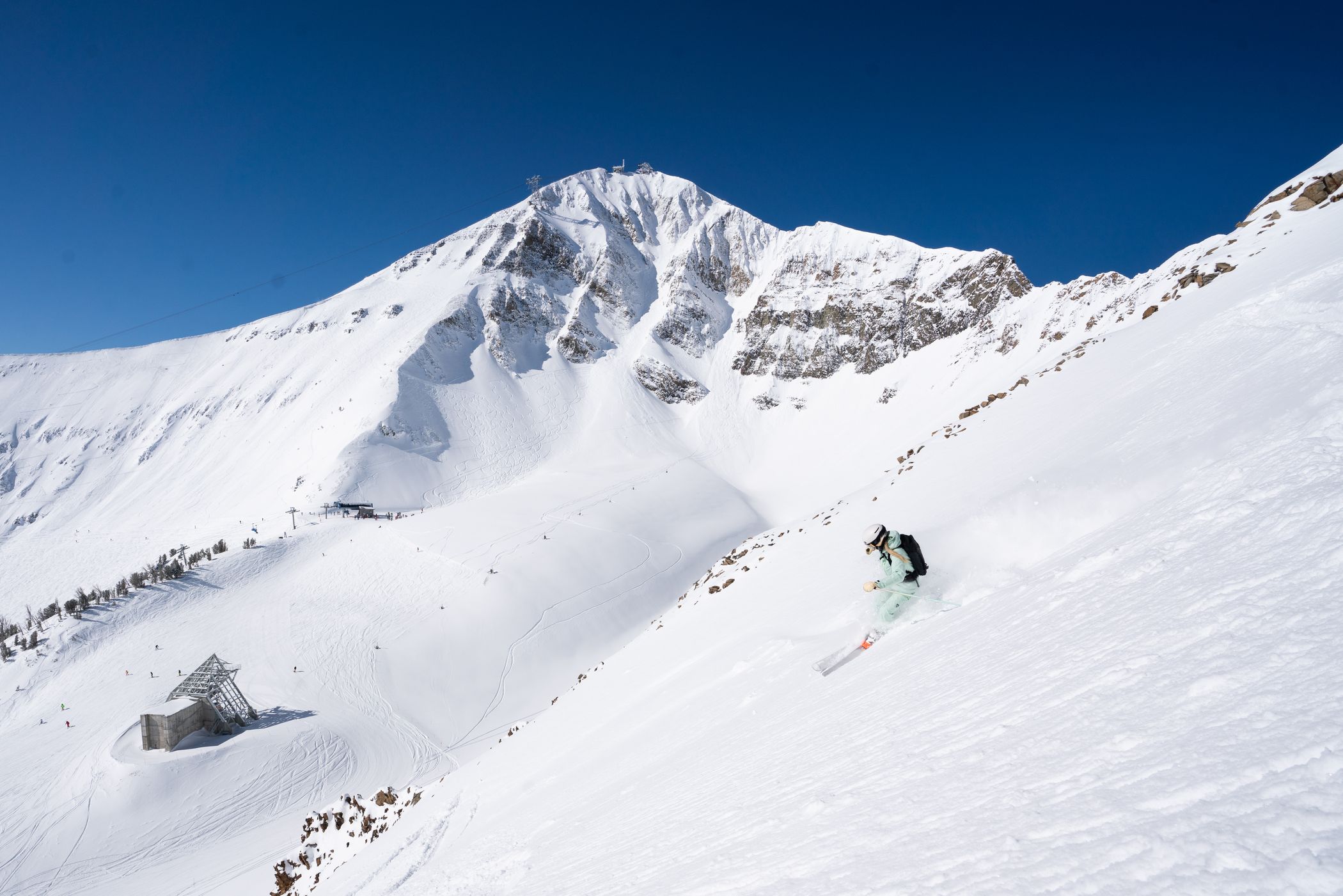 Skier in powder at Big Sky Resort with Lone Peak in the background