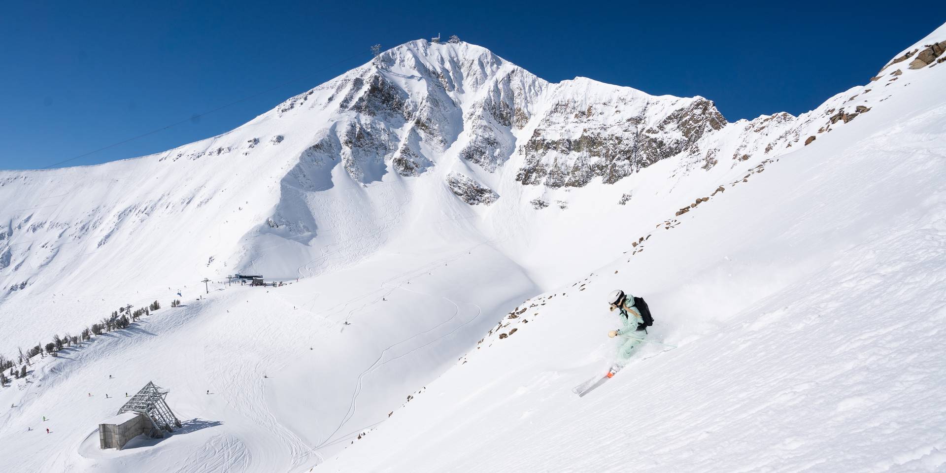 Skier in powder at Big Sky Resort with Lone Peak in the background