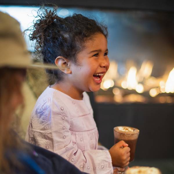 Girl smiling holding hot chocolate