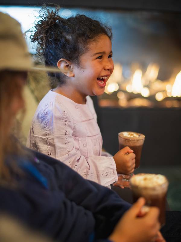 Girl smiling holding hot chocolate