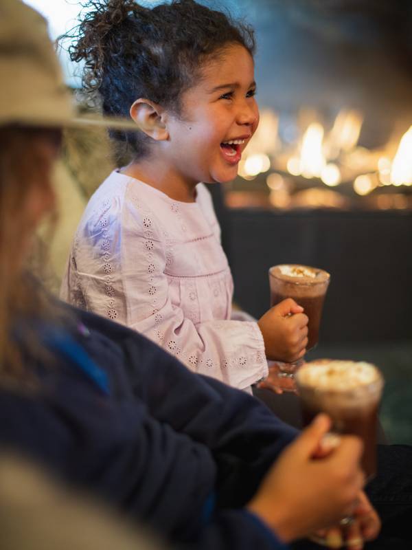 Girl smiling holding hot chocolate