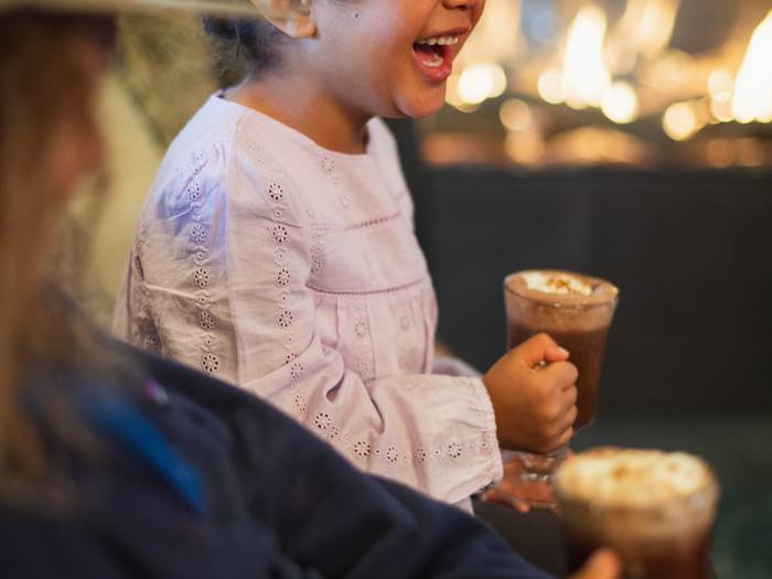 Girl smiling holding hot chocolate