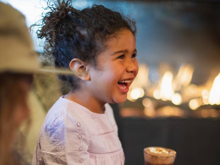 Girl smiling holding hot chocolate