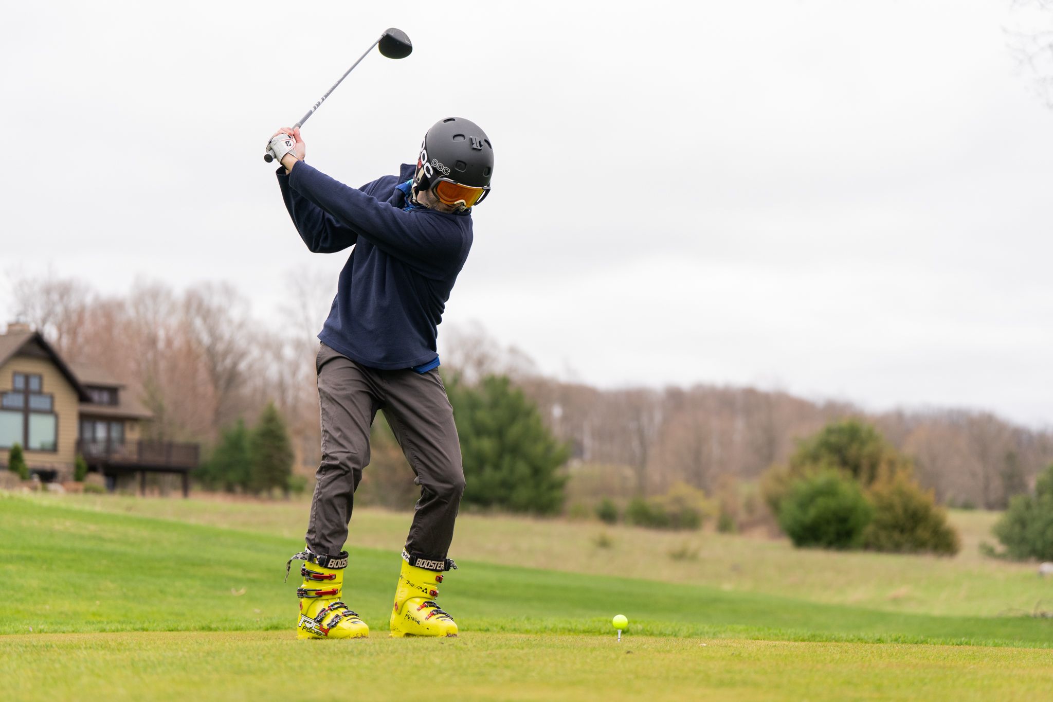 Golfing Teeing off with ski boots and ski boots