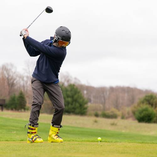 Golfing Teeing off with ski boots and ski boots