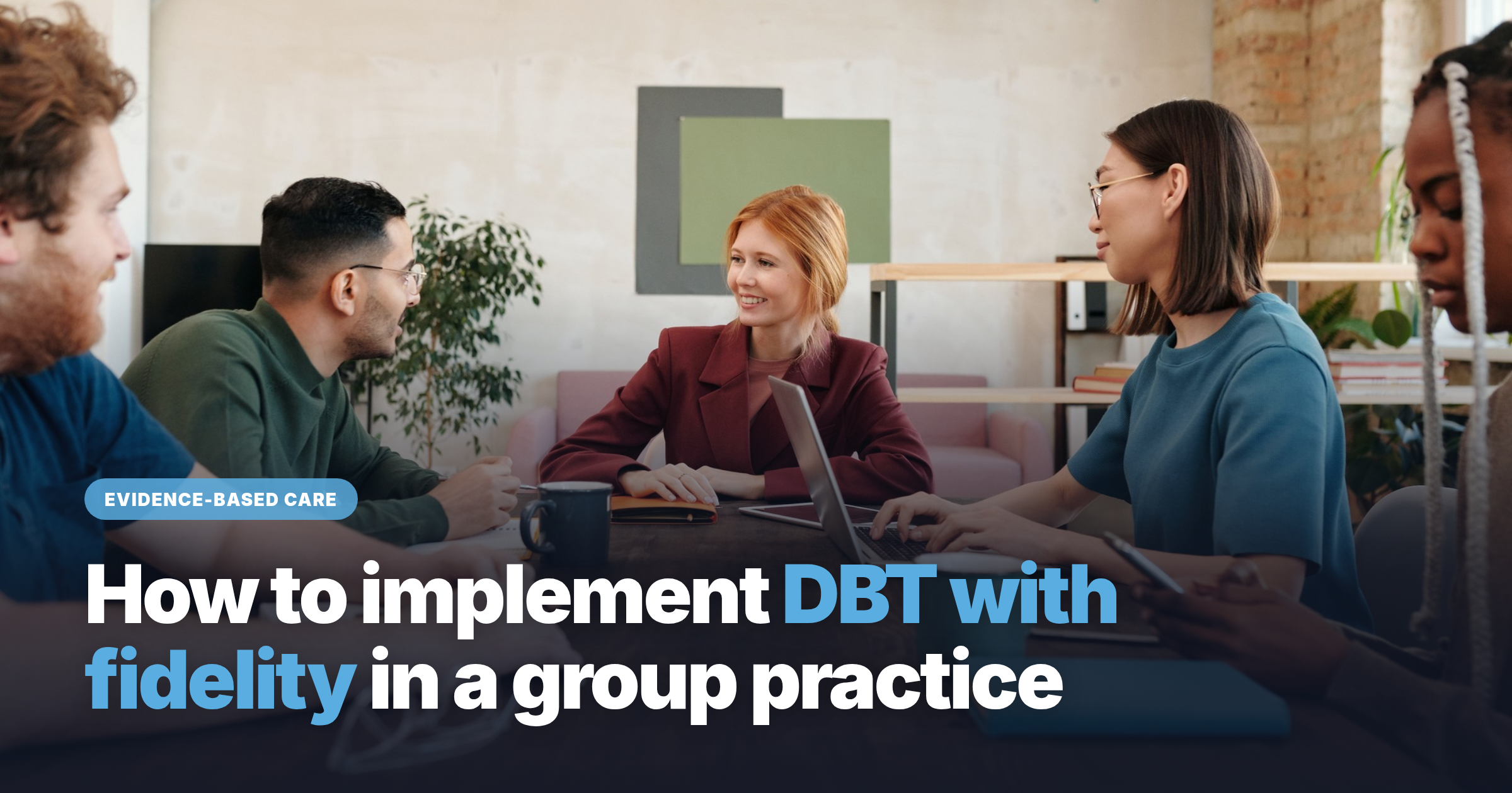 Group practice team meeting around a conference table to plan a DBT program. 