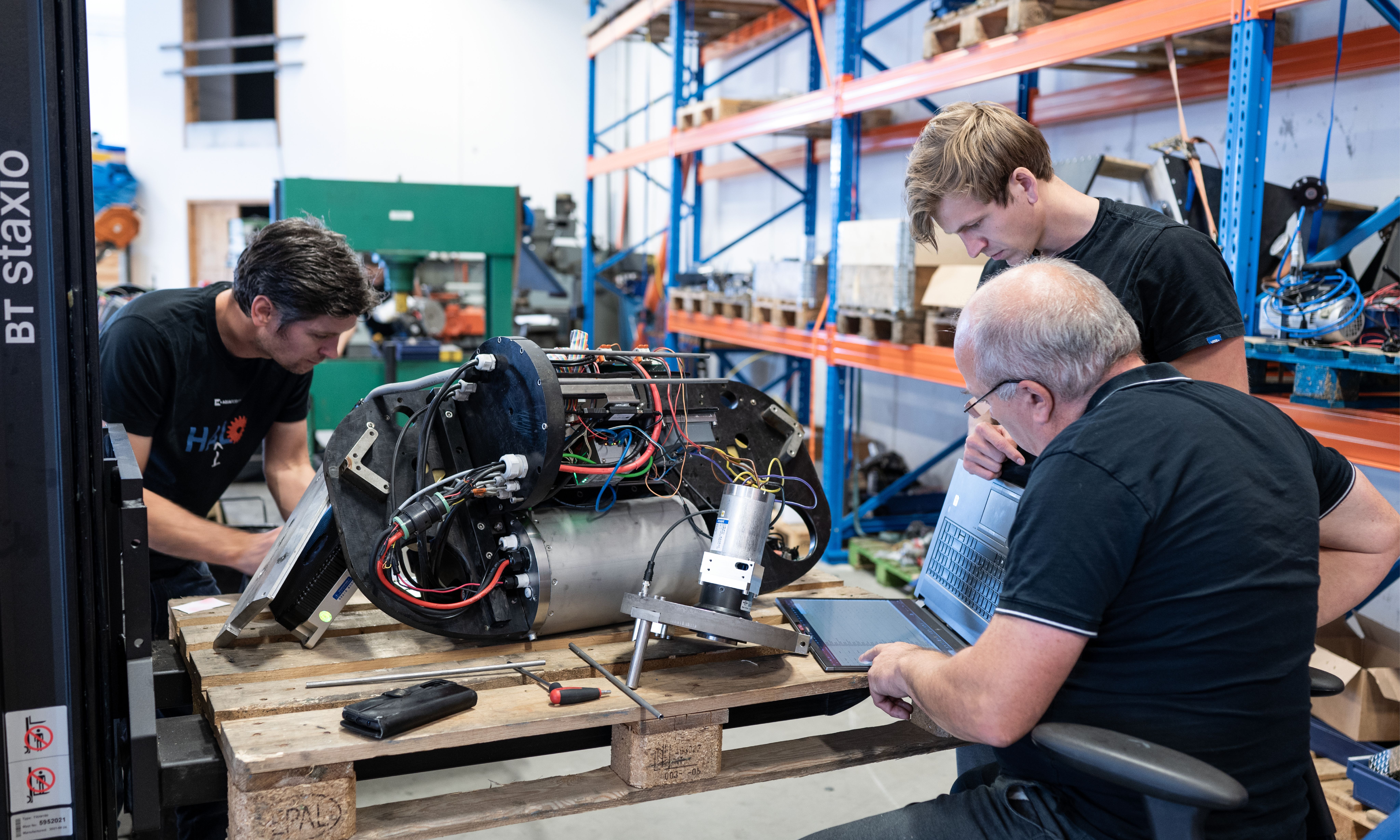Thee men working on electronics