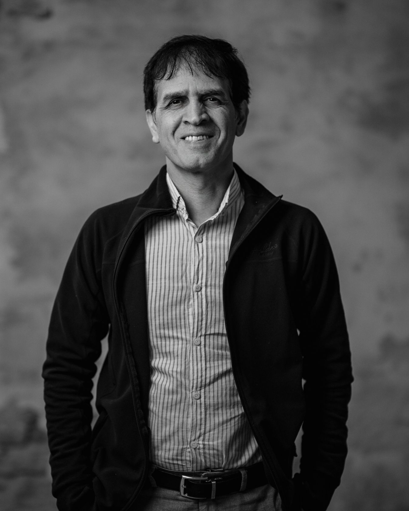 Blurry black-and-white headshot of a man with dark hair facing the camera