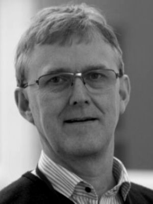 Black-and-white portrait of a middle-aged man wearing glasses and a collared shirt