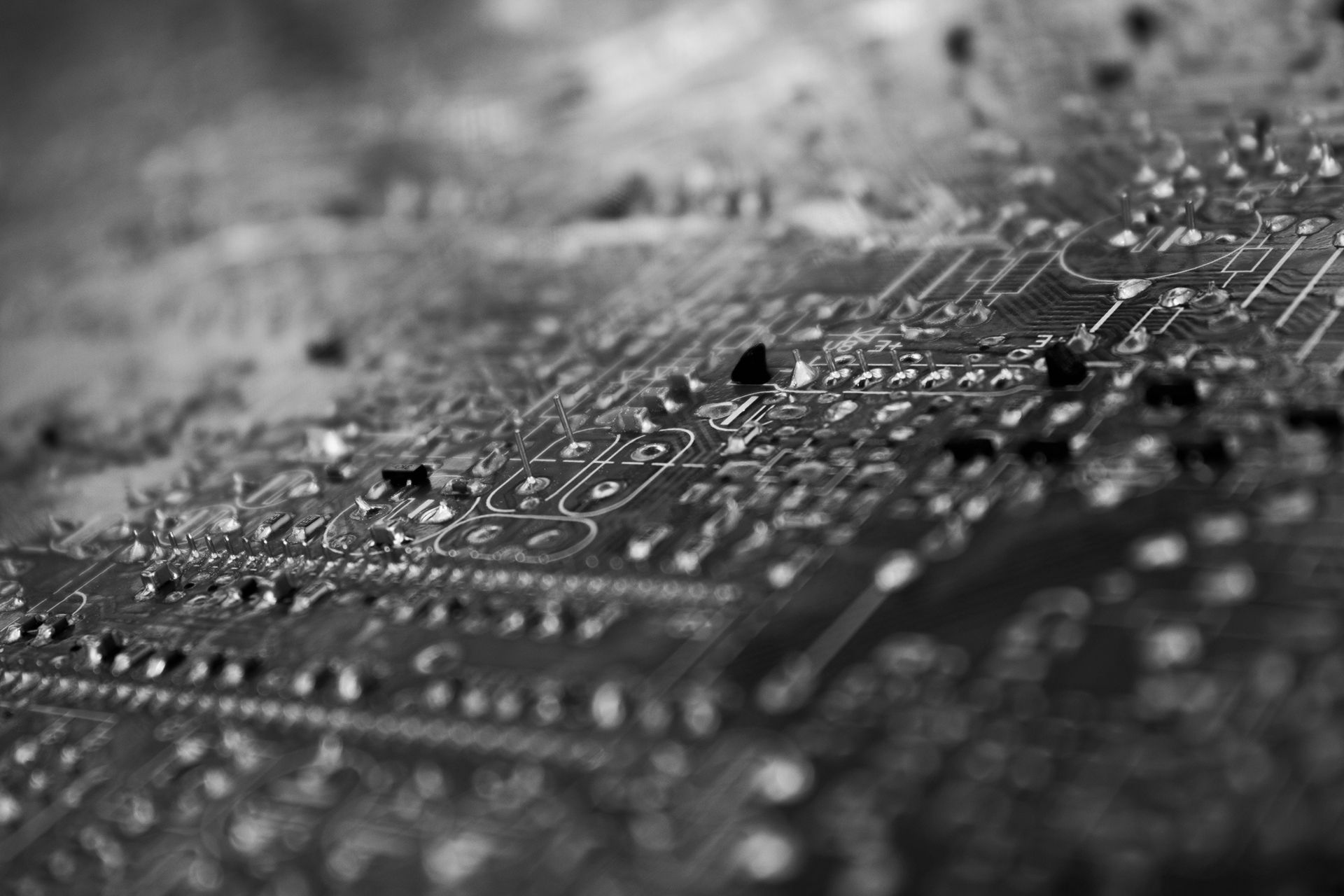 Black-and-white close-up of a circuit board with soldered components