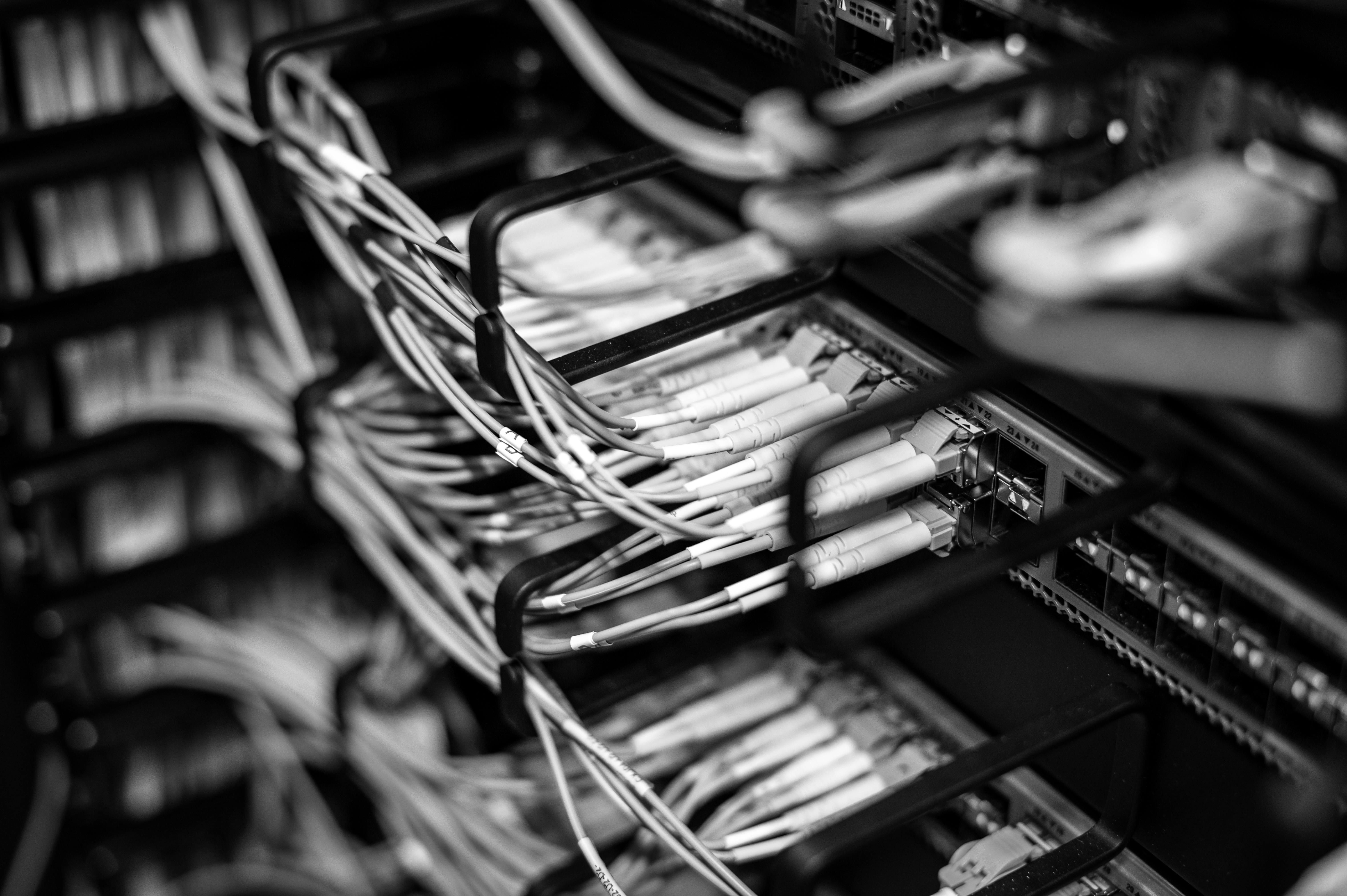 Close-up of network cables plugged into server racks in a data center