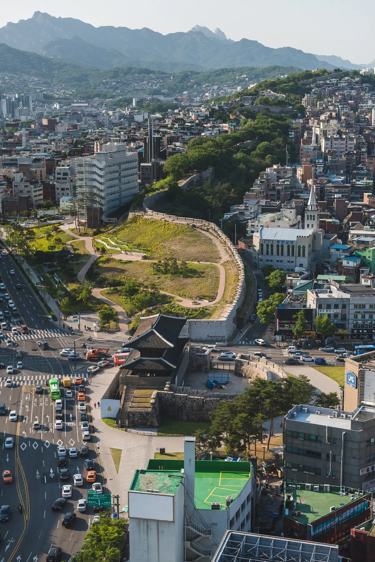 Cityscape of Seoul from Dongdaemun including the City Wall, residential neighborhoods and Bukhansan Mountain