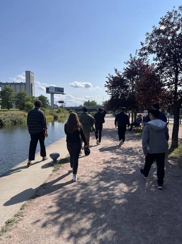 Team members walking together along a waterfront path