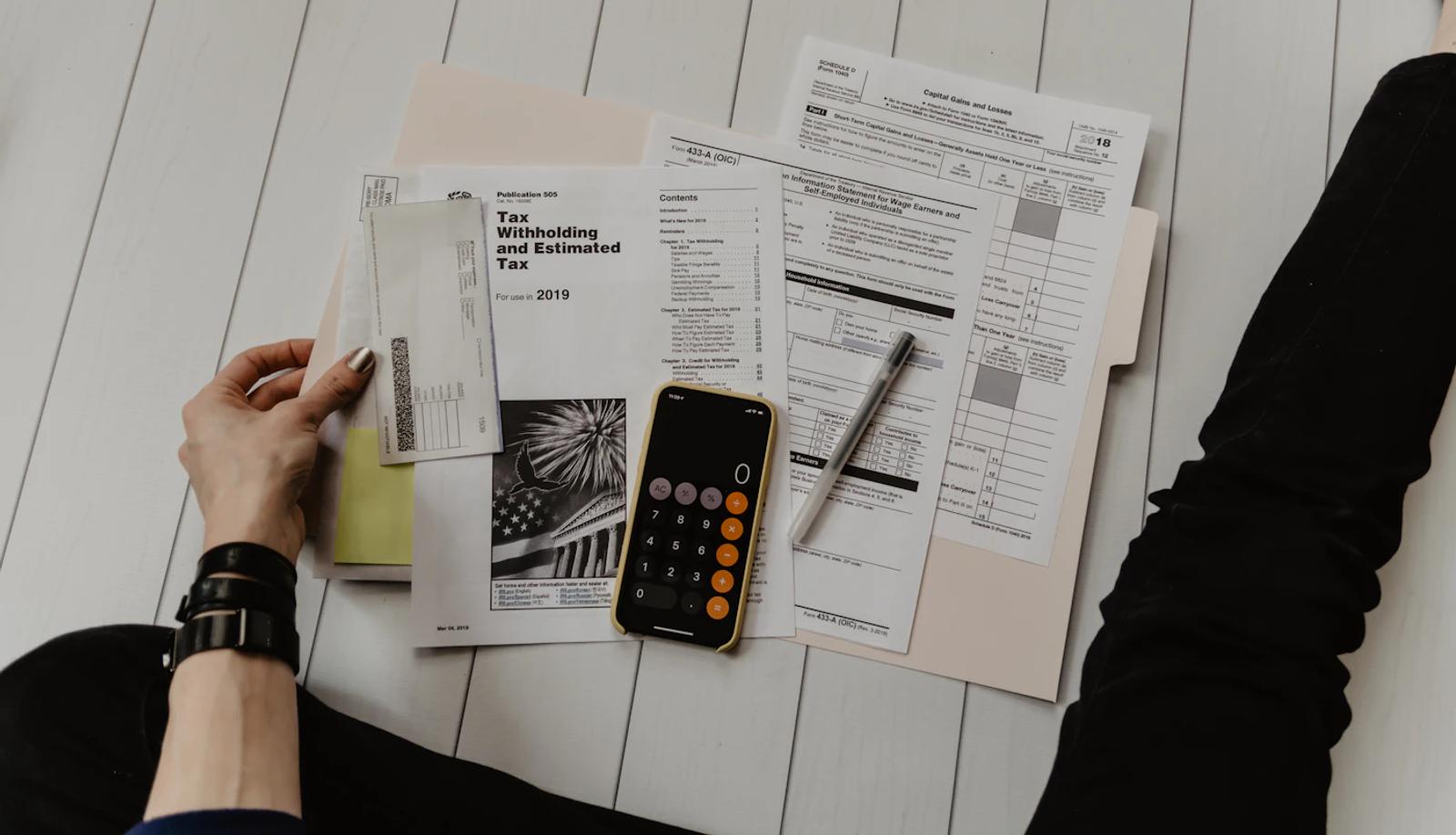 Financial documents and a calculator on a desk